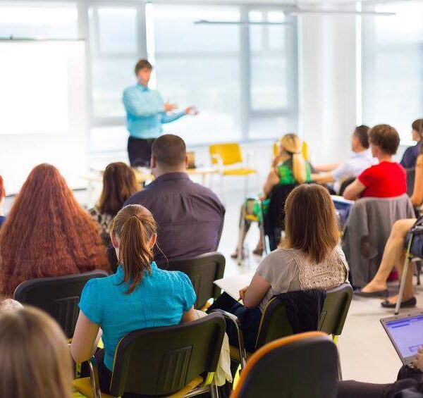 Speaker at business workshop and presentation. Audience at the conference room.